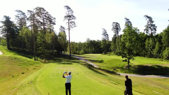 Unrecognizable professional golfer hits ball on golf course of Molndal near Gothenburg, Sweden. Aeri