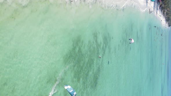 Vertical Video Kitesurfing Near the Shore of Zanzibar Tanzania Aerial View