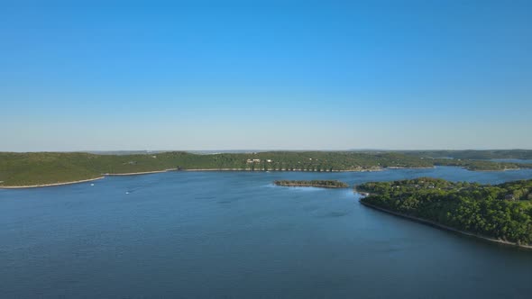 Aerial Birds Following View of a Hige River Bay and the Green Rainforest Under the Setting Sun