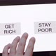 Close-up of a man's hand between the RICH and POOR buttons - VideoHive Item for Sale