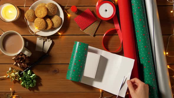 Woman Wrapping Earphones for Christmas Gift