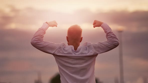 Attractive Muscular Man Rising Hand Showing Strong Celebrating Victory Amazing Sunset Sky Background
