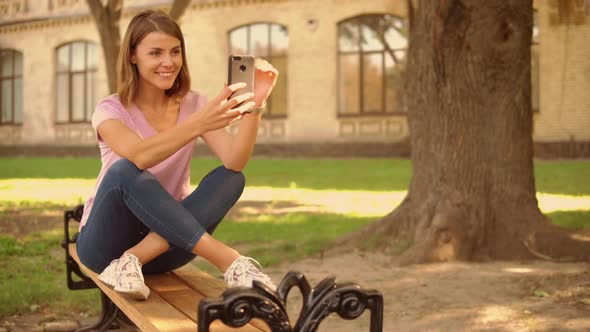 Young Woman Chatting Online Near College