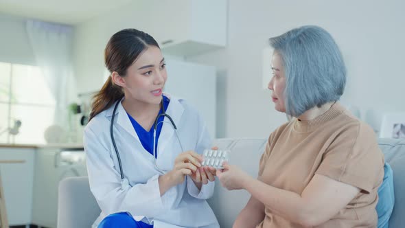 Caregiver therapist pharmacist girl hold medicine explain prescription to elderly older patient.