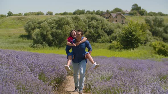 Joyful Man Giving Piggyback Ride To Woman Outdoor