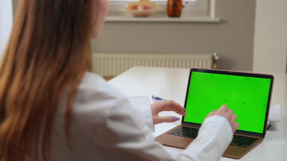 Chromakey Laptop with Blurred Doctor Waving Greeting Patient in Video Chat