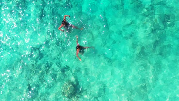 Sexy fun women travelling in the sun at the beach on summer white sandy and blue 4K background