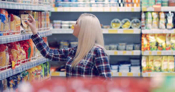 Woman Buys Food in a Shopping Center