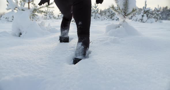 Woman Walking in Deep Snow on Sunny Winter Day Feet and Boots Close Up