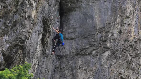 A man rock climbing up a mountain.