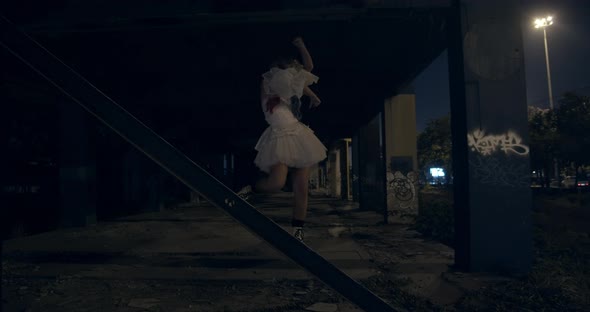 Woman in White Dress and Harleyquin Makeup Balancing on Metal Railings