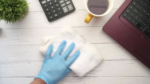 Person Hand in Disposable Gloves Clean Table Surface
