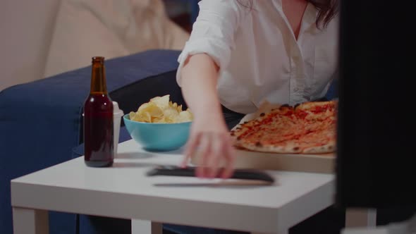 Close Up of Woman Placing Box of Pizza on Table