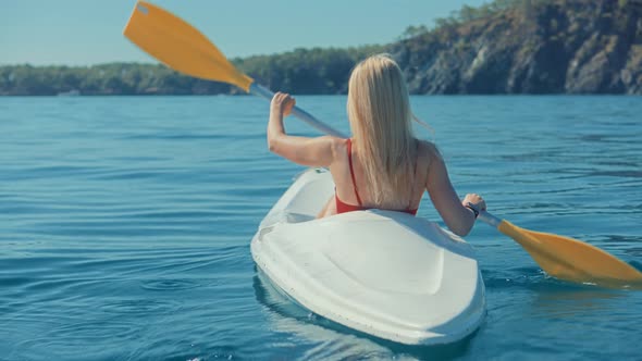 Paddling Canoe Adventure. Tourist Woman Spending Day Kayaking On Sea. Active Woman Having Fun.