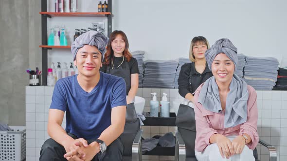 Portrait of Asian Couple, man and woman on salon washing bed getting hair washed in beauty salon.