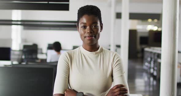 Portrait of african american businesswoman smiling and standing in office