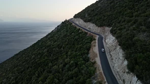 Car Travel Concept Aerial View of Mountain Road Near Sea at Lefkada Island