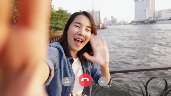 Attractive of Asian female taking selfie video chat with her friends sharing enjoyment vacation.