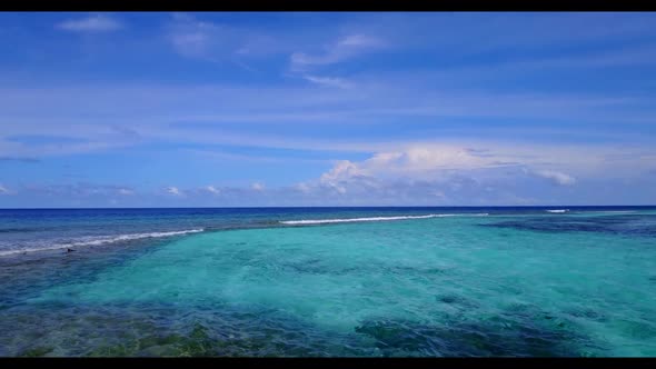 Aerial above scenery of relaxing coastline beach lifestyle by aqua blue lagoon with clean sand backg