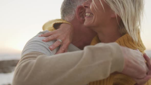 Happy senior couple dancing at beach