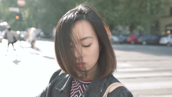 Portrait of a Lonely chinese woman in a urban street feeling sad