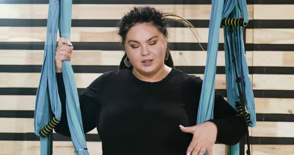 Happy Body Positive Woman Smiling and Laughing After Doing Stretching Exercise on Hammocks