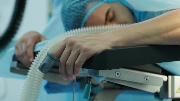 The Patient Lies On The Operating Table With A Pulse Oximeter On His Finger. 