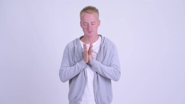 Angry Young Blonde Man with Arms Crossed