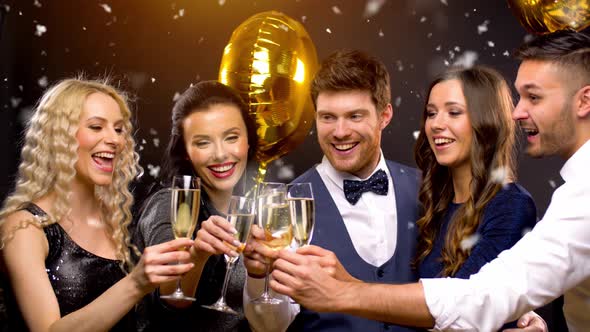 Happy Friends Clinking Champagne Glasses at Party