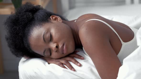 Serene African American Woman Sleeping Waking Up in Comfortable Bed Lying on Soft Pillow Orthopedic