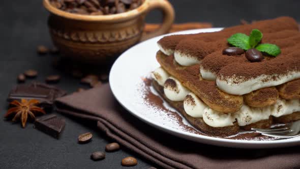 Classic Tiramisu Dessert on Ceramic Plate on Dark Concrete Background