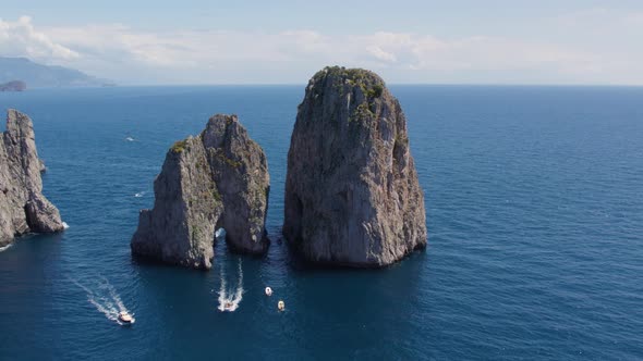 Boats Exploring Famous Travel Destination - The Faraglioni Rocks, Italy