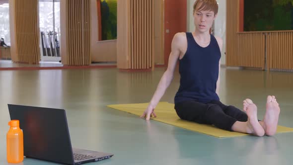 a Young Cute Gymnastics Coach Conducts a Remote Online Class for Those Who Did Not Come To Practice