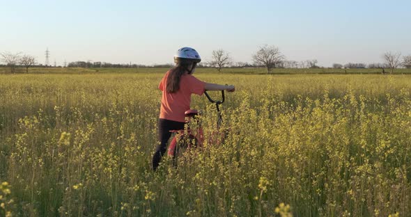 With Bike in the Flowers Field