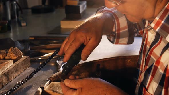 Goldsmith using hand piece machine