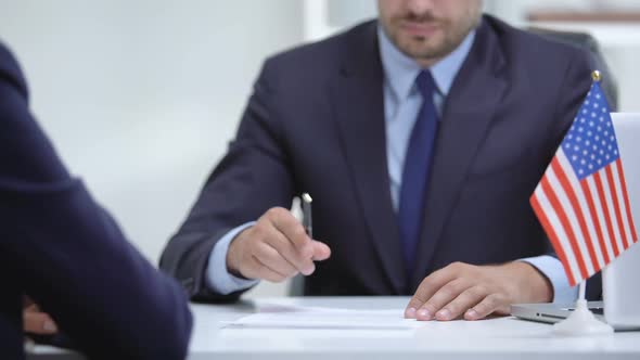 US Official Signing Contract for International Cooperation, Shaking Partner Hand