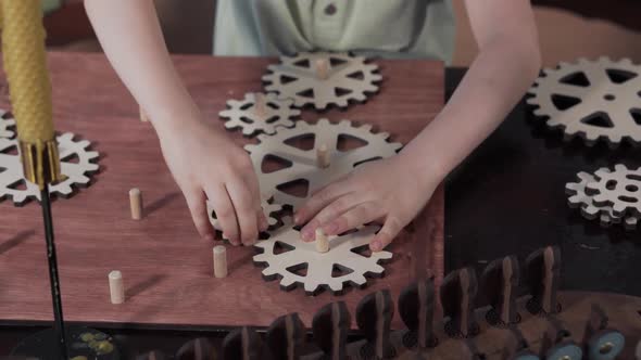 Closeup of a Child Who Collects Wooden Gears
