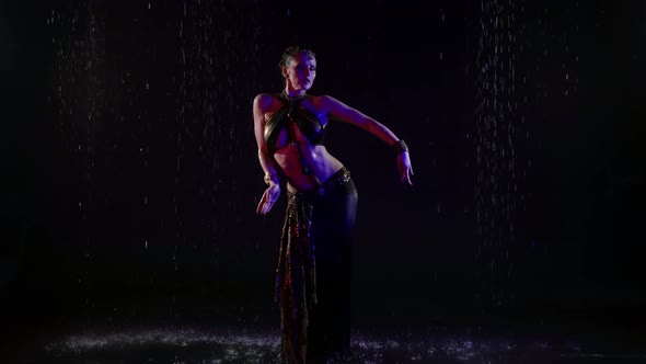 Professional Arabic Dance Performer is Dancing Under Rain Mysterious Female Figure