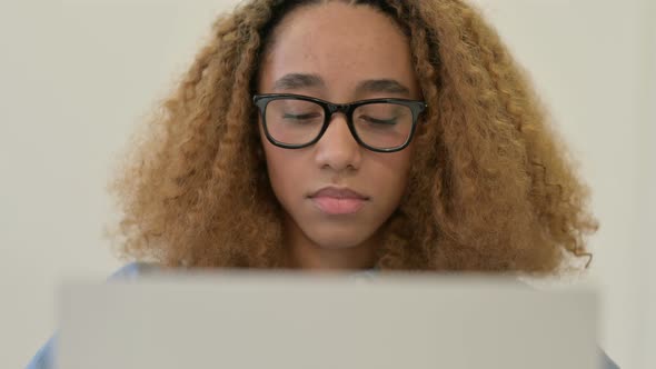 Portrait of African Woman Working on Laptop in Office