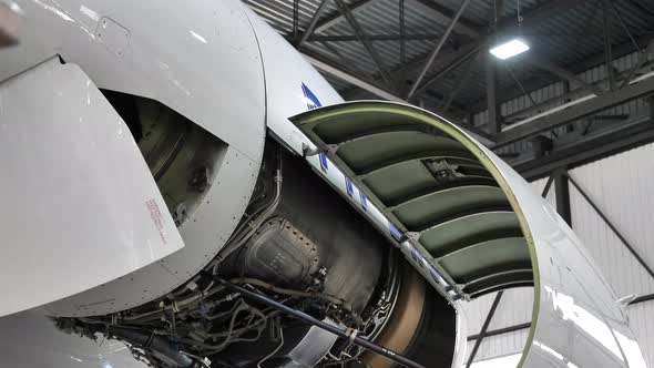 Close Up Open Aircraft Jet Engine in Maintenance Facility. Tilt Down