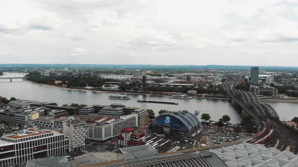 Aerial 4k footage of the Hohenzollern Bridge crossing the Rhine River in historic Cologne, Germany