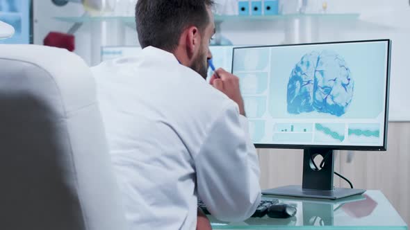 Doctor Analyzing 3D Brain Simulation on a Computer Screen alt