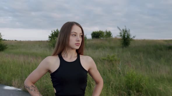 Portrait of Beautiful Athletic Girl Purposefully Looking at the Camera Outdoors