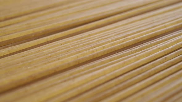 Macro textured surface of raw integral spaghetti stacked in geometric parallel shape