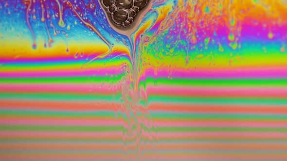Macro shot of a soap bubble creates a colorful and psychedelic background. Rainbow colors. 