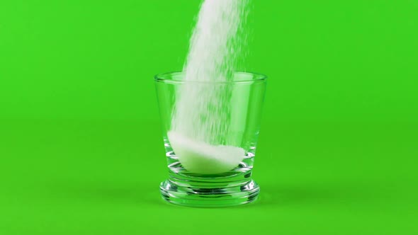 Pour Sugar Shot Glass Thick Bottom Green Contrasting Background Slow Motion