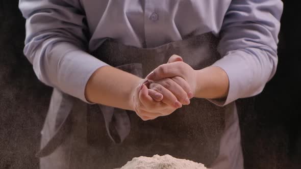 Woman Cook Claps Her Hands with Flour in Her Hands