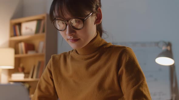 Asian Businesswoman Working in Office in Evening