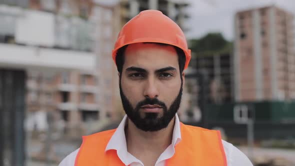 Portrait of Construction Worker on Building Site Looking at the Camera.