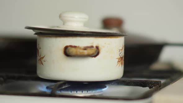 Pan Is on the Stove with the Gas Turned on Moving Camera